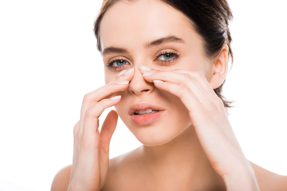 beautiful woman touching nose after rhinoplasty Functional rhinoplasty